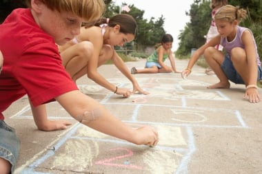 kids drawing with sidewalk chalk