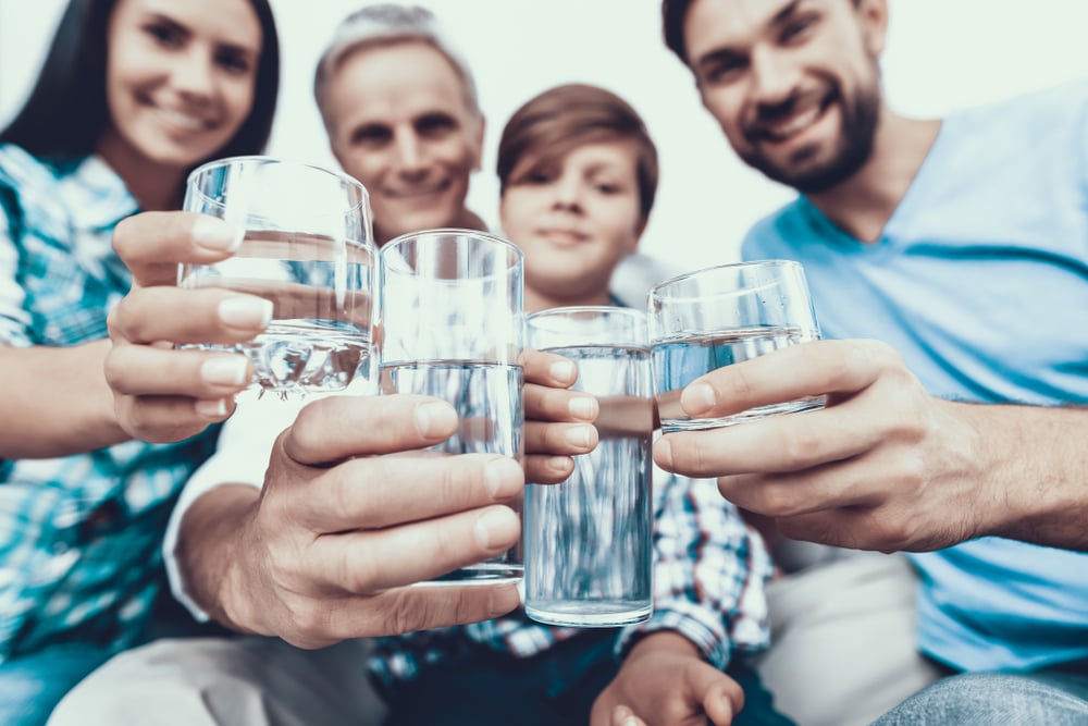 smiling family drinking water