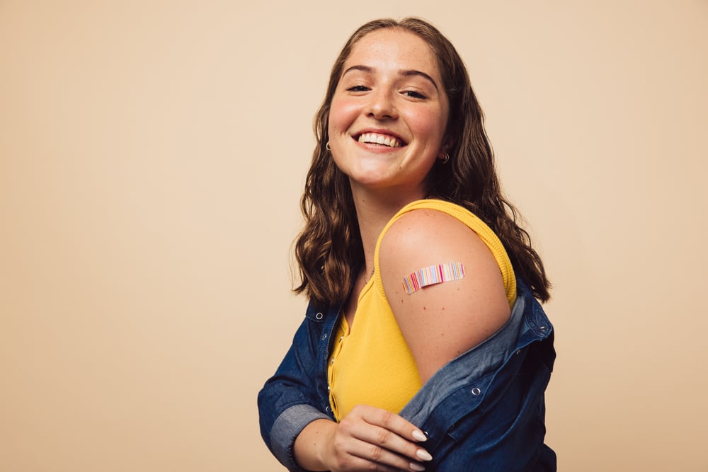 woman showing off her vaccine